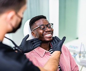 Patient nodding off to the effects of dental sedation while dentist works
